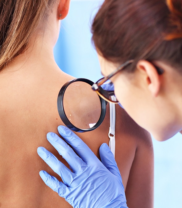 Dermatologist checking a patient's skin