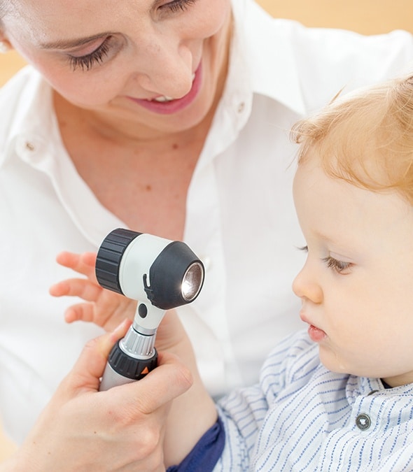 Dermatologist inspecting a toddler's skin