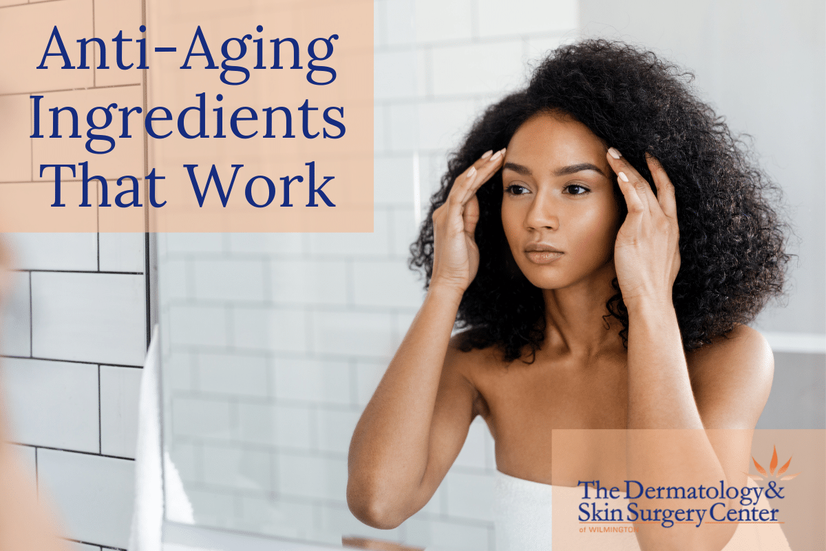 Woman Looking At Her Youthful Appearance In The Mirror With Results From Anti-aging Ingredients That Work - The Dermatology & Skin Surgery Center Of Wilmington